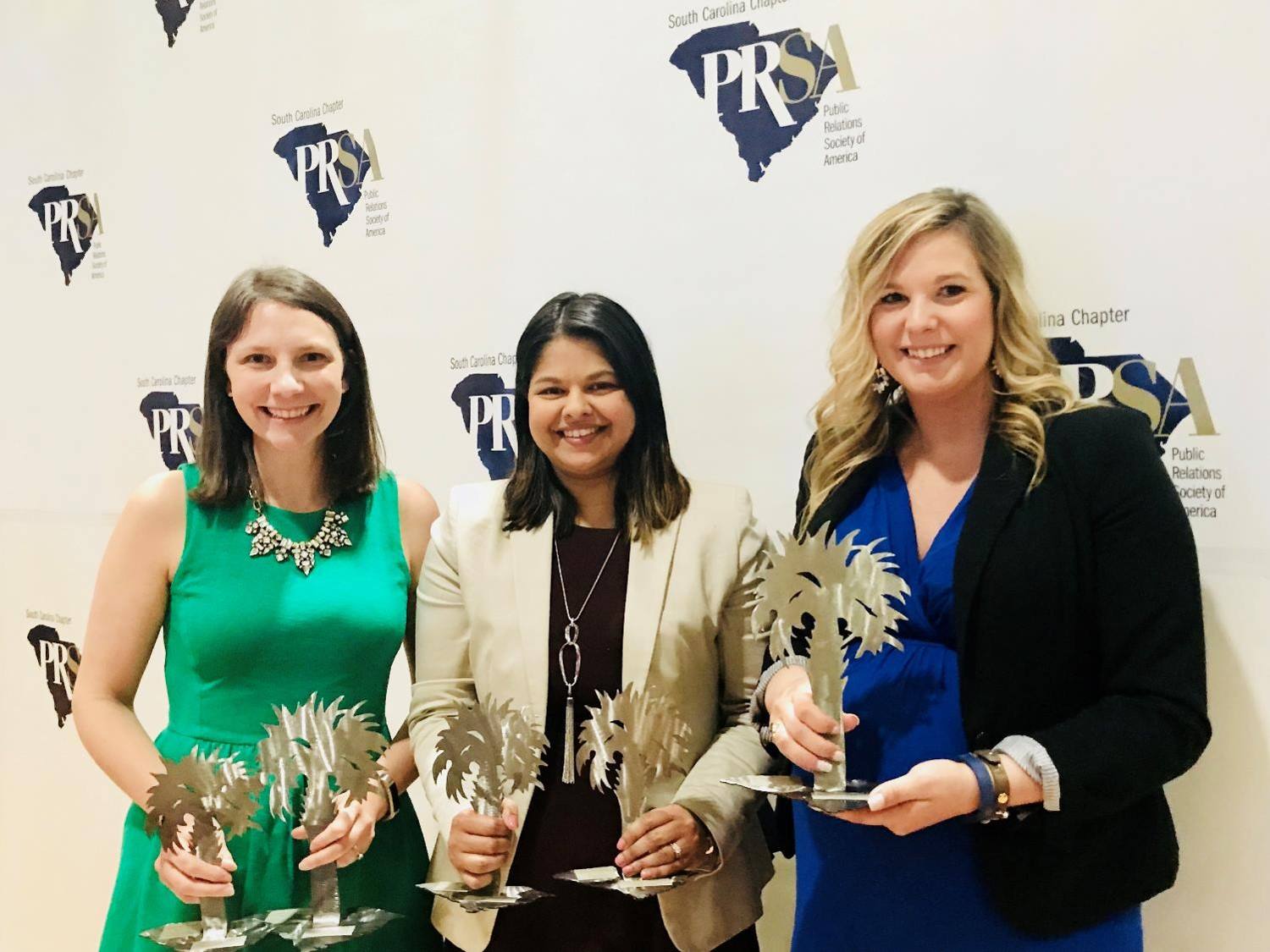 Three ladies holding Mercury Awards