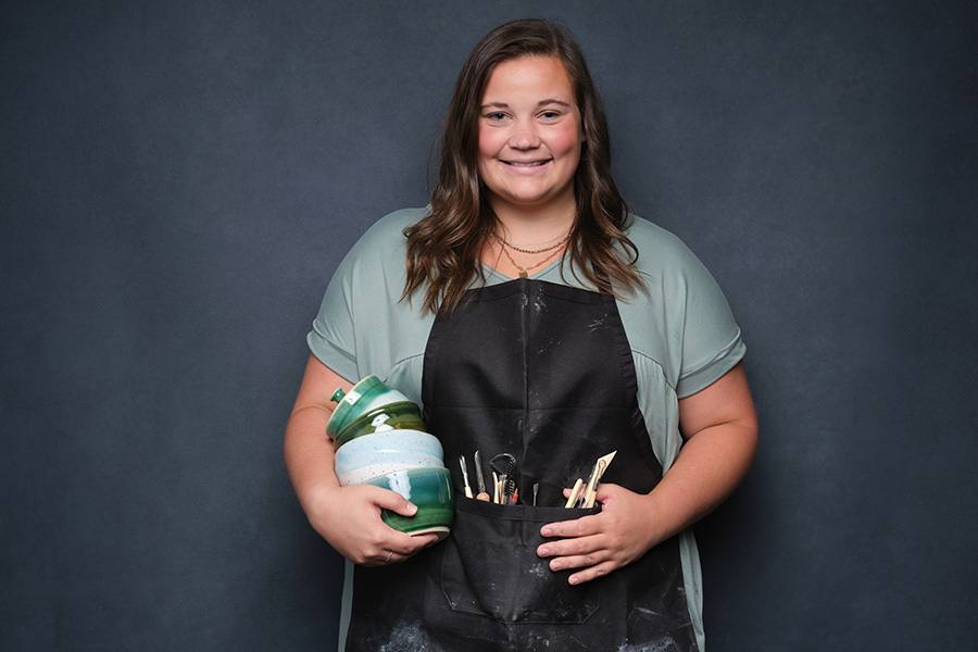 Abbie with ceramics and working apron