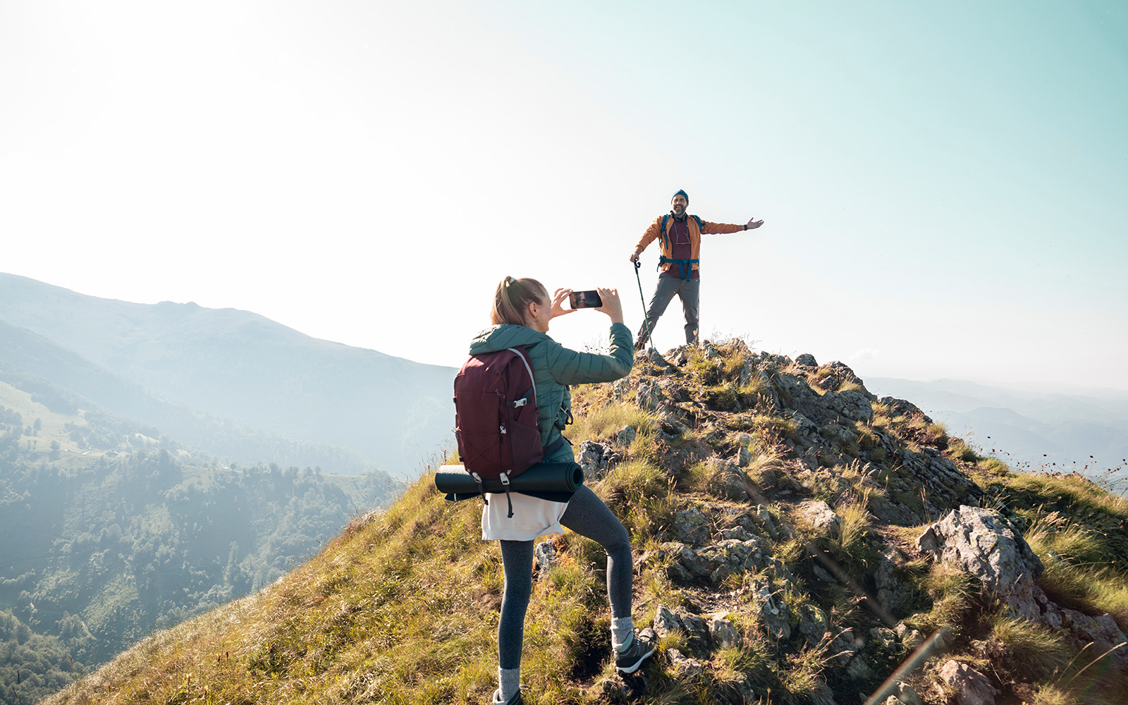 a couple on vacation hikes together in the mountains